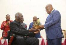 President Akufo-Addo (right) presenting an award to Former President Kufour at the programme