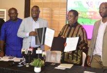 • Dr Awal (second from left) and Mr Gumede displaying the signed MoU Photo: Victor A. Buxton