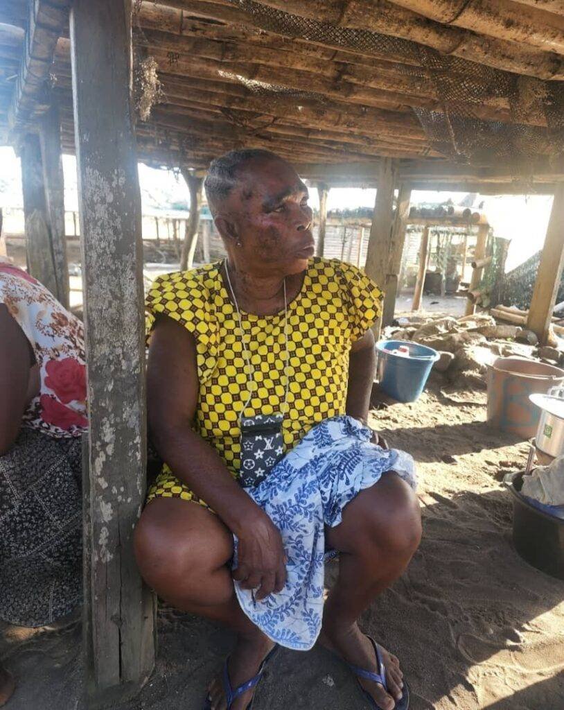 Abena seated close to where she dries her salted fish