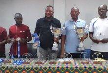 Mohammed Awudu Aputeog (third left) together with Mr. Awuku Akuffo display the trophies and medals together with other invited guest