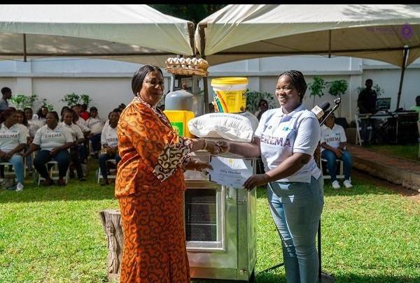 Mrs Rebecca Akufo-Addo (left) presenting a certificate and cash to one of the beneficiaries
