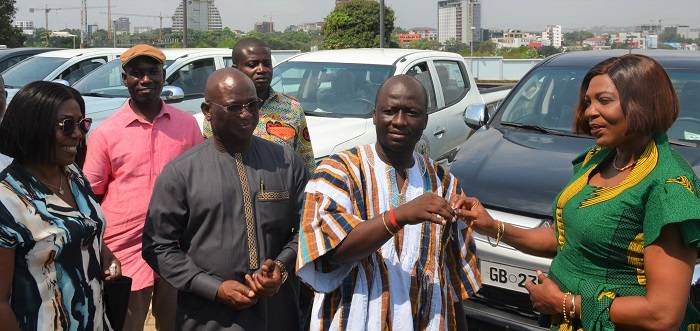 Mr Frederick O. Adom, Deputy Transport Minister (in smock), handing over the keys to the vehicles to Mrs Elizabeth Sackey on behalf of the beneficiaries Photo: Godwin Ofosu-Acheampong