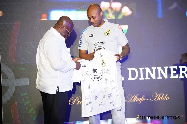 • Black Stars skipper, Andre Ayew (right), presents a team’s jersey to the President