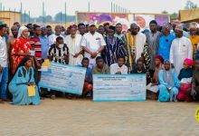 • Alhaji Farouk Aliu Mahama (middle, in cap) with the beneficiaries and their parents