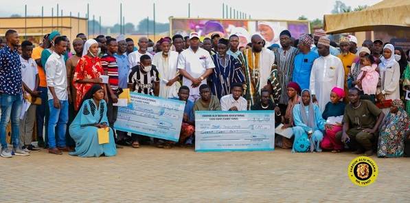 • Alhaji Farouk Aliu Mahama (middle, in cap) with the beneficiaries and their parents