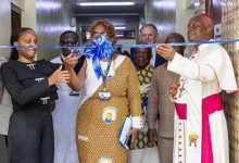 Dr Oyeyinka (left) and Dr Maite Alfonso Romero, cutting the tape to open the facility that houses the MRI Scanner. Looking on are Most Rev Afrifah-Agyekum (right) and other dignitaries.