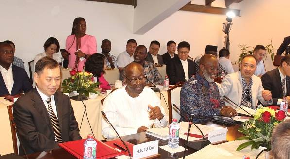 Mr Ken Ofori-Atta (second from left) interacting with Ambassador Lu Kun (left) at the programme. Photo. Ebo Gorman
