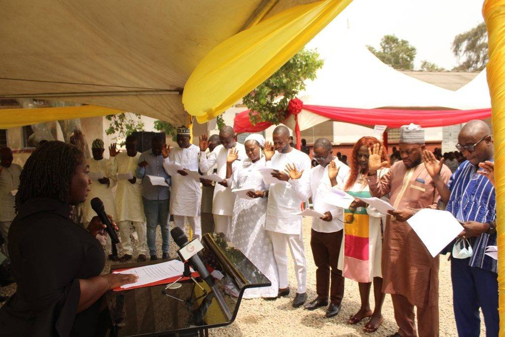 Her Worship Bernice Mensimah Ackon with mic swearing in the assembly members at the Ayawaso East Municipal Assembly. Photo. Ebo Gorman