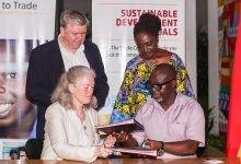 • Mrs Marianne Thyrring exchanging the signed documents with Mr Asuman. With them are Mr Nørring and Madam Boateng