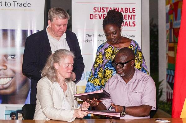 • Mrs Marianne Thyrring exchanging the signed documents with Mr Asuman. With them are Mr Nørring and Madam Boateng