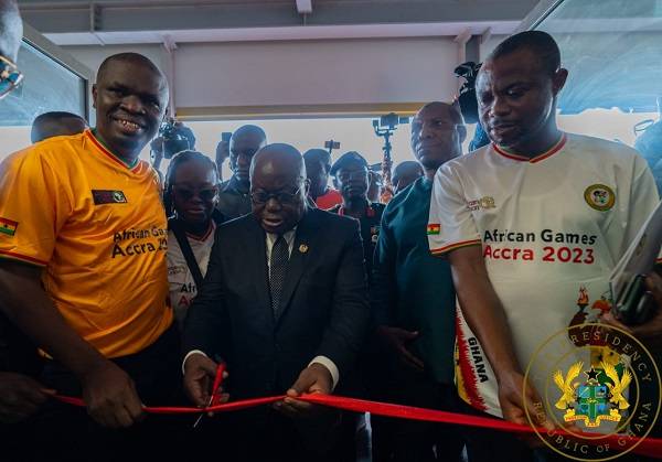 President Akufo-Addo (middle) cutting a tape to officially open the Borteman Sports Complex facility