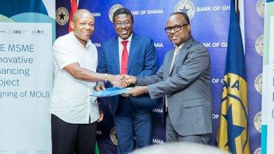 • Dr Opoku-Afari exchanging the MoU with Mr K. Duker (left), the Chief Executive Officer of DBG, while Prof Bawole (middle) looks on