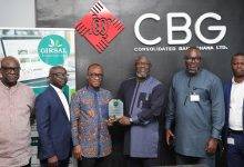 • Mr Addo (third from left) displaying the award