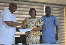 Ms Elisabeth Sackey, AMA Mayor (middle) handing over her signed document to Mr Quartey while Mr Douglas Annoful, the Coordinating Director looks on  Photo: Godwin Ofosu Acheampong 