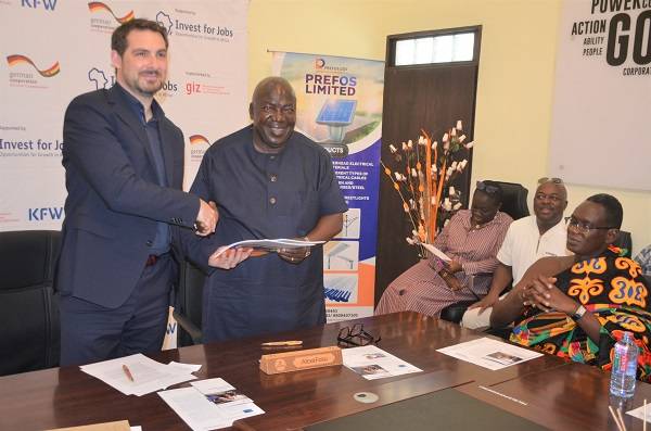 Mr Steffen Kuhl,MD,Investing For Employment, exchanging the signed document with Mr Alexie Kwasi Fosu, Executive Director Prefos while other look on. Photo Godwin Ofosu-Acheampong