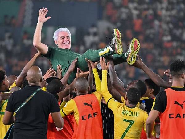 • South Africa players celebrating with coach Hugo Broos after the game