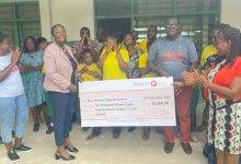 Team Fidelity Bank presenting the cheque to the management of the school