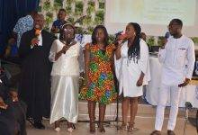 Rev. Ankama-Asamoah  (left) and the family singing during the induction