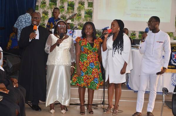 Rev. Ankama-Asamoah  (left) and the family singing during the induction