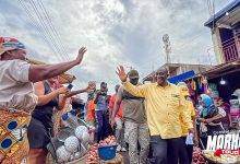 • Mr Alan Kyerematen waving at the market women on his tour at the Central Region