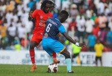 • Kotoko's Richmond Lamptey (in red) tackling a Nations FC player