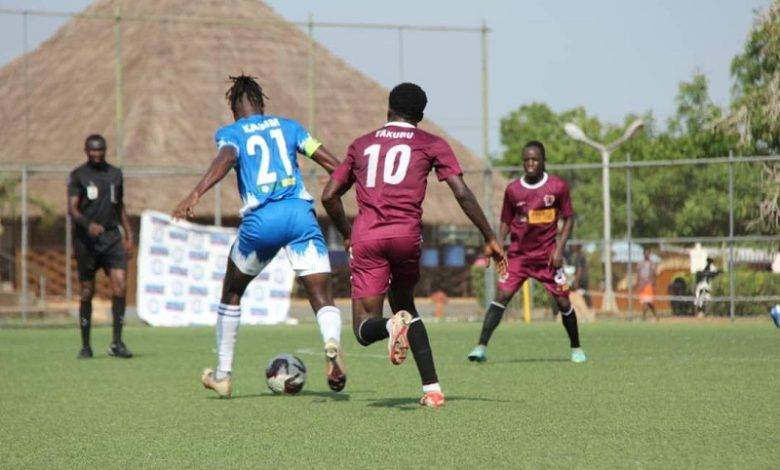 Oly skipper, Kassim (left) is challenged by a Heart of Lions midfielder