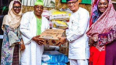 Dr Mustapha Abdul-Hamid (second from right) presenting the items to a representative of Chief Imam