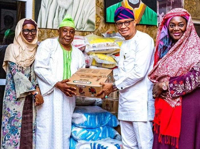 Dr Mustapha Abdul-Hamid (second from right) presenting the items to a representative of Chief Imam