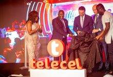 • Dr Bawumia (second from left) being assisted by officials of Telecel to unveil the brand