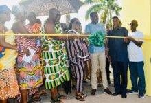 • Dr Asare (middle) being assisted by other dignitaries to officially cut the ribbon to open the Adinkra show