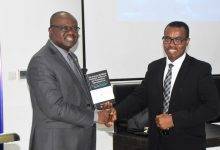 Mr Kwaku Ampratwum-Sarpong (left) congratulating Dr Senilor Kwabla Yawlui after the book launch