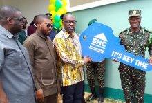 • Mr Kojo Oppong Nkrumah (second from right) handing over a symbolic key to Mr Kwame Asuah Takyi, Comptroller-General of GIS