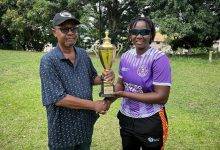 • Mr John Williams, President of Obuasi Sports Club, presenting the trophy to Rhyda Ofori Amanfo