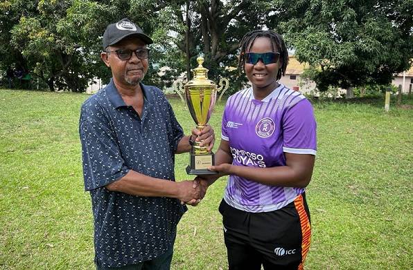 • Mr John Williams, President of Obuasi Sports Club, presenting the trophy to Rhyda Ofori Amanfo