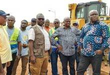 Mr Francis AsensoBoakye (third from left)and his entourage inspecting some road works in the Ahafo Region