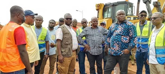 Mr Francis AsensoBoakye (third from left)and his entourage inspecting some road works in the Ahafo Region