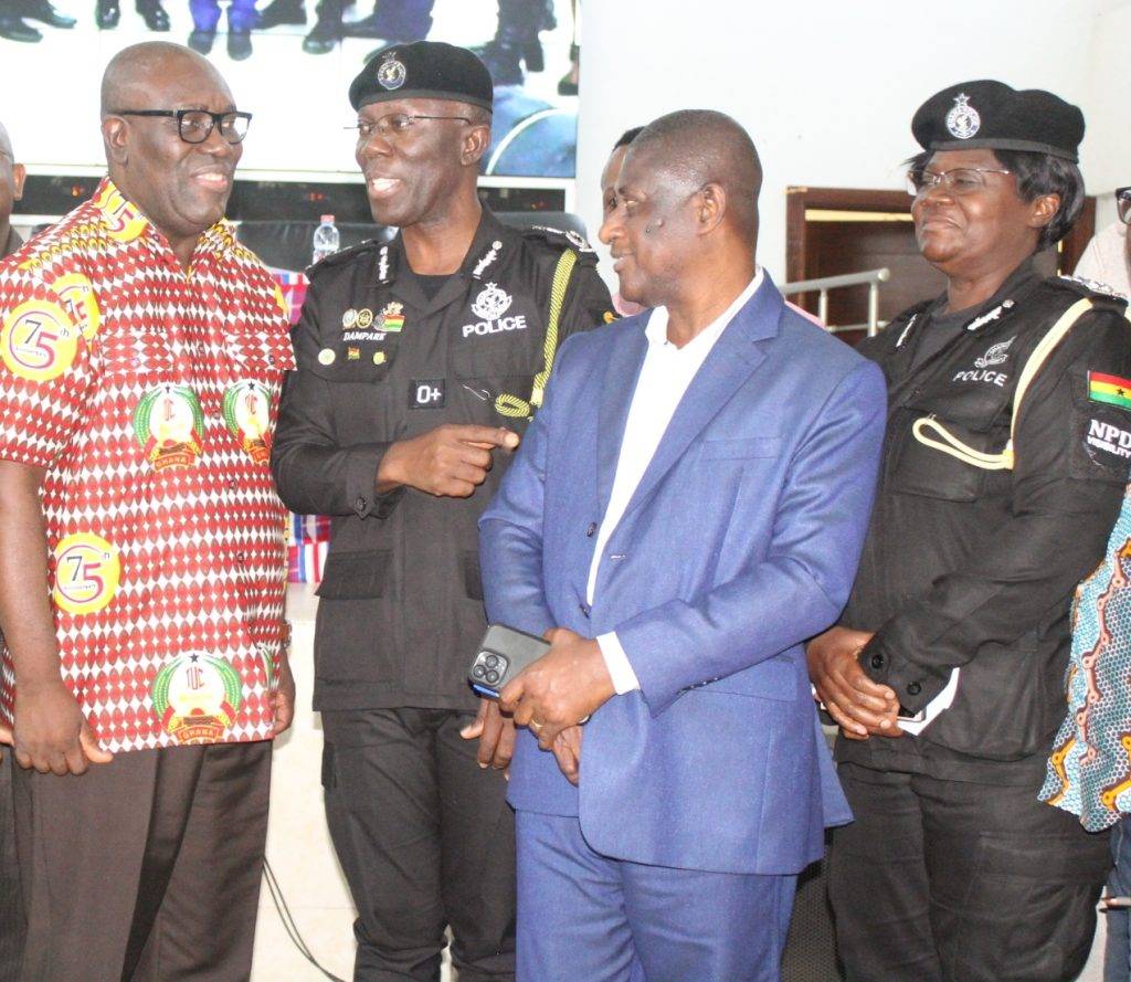 IGP Dr Akuffo Dampare (middle) interacting with Dr Anthony
Baah (left), and Mr Samuel Tettey (second from right) after the
forum Photo: Ebo Gorman