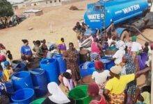 • Residents queuing to buy water from a tanker