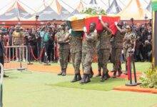 Personnel from the Immigration service carrying the remains of Dr John Ampontua Kumah for burial