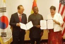 Mr Kyongsig (left) and Ms Palmer (right) with the MOU. With them is Mr Aboagye