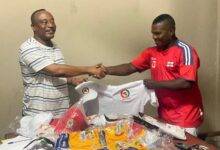 • Mr Walker (left) presenting shirts to the Vice President of C/R GBF