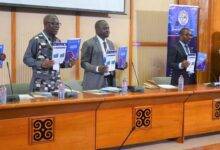 Prof S K Annim (middle) with Prof Kwaku Appiah-Adu,Senior Policy Advisor, Office of Vice Pres and other dignitaries with the report during the launching. Photo Godwin Ofosu-Acheampong